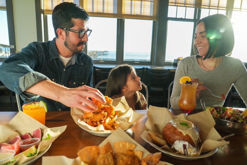 Best Things to Do Near the Ventura Pier Family enjoying Eric Ericsson’s by the Ventura Pier