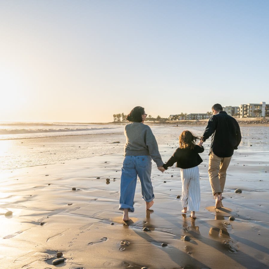 Why Ventura Is the Perfect Road Trip Stop on the Way to Los Angeles family walking at Ventura Pier beach
